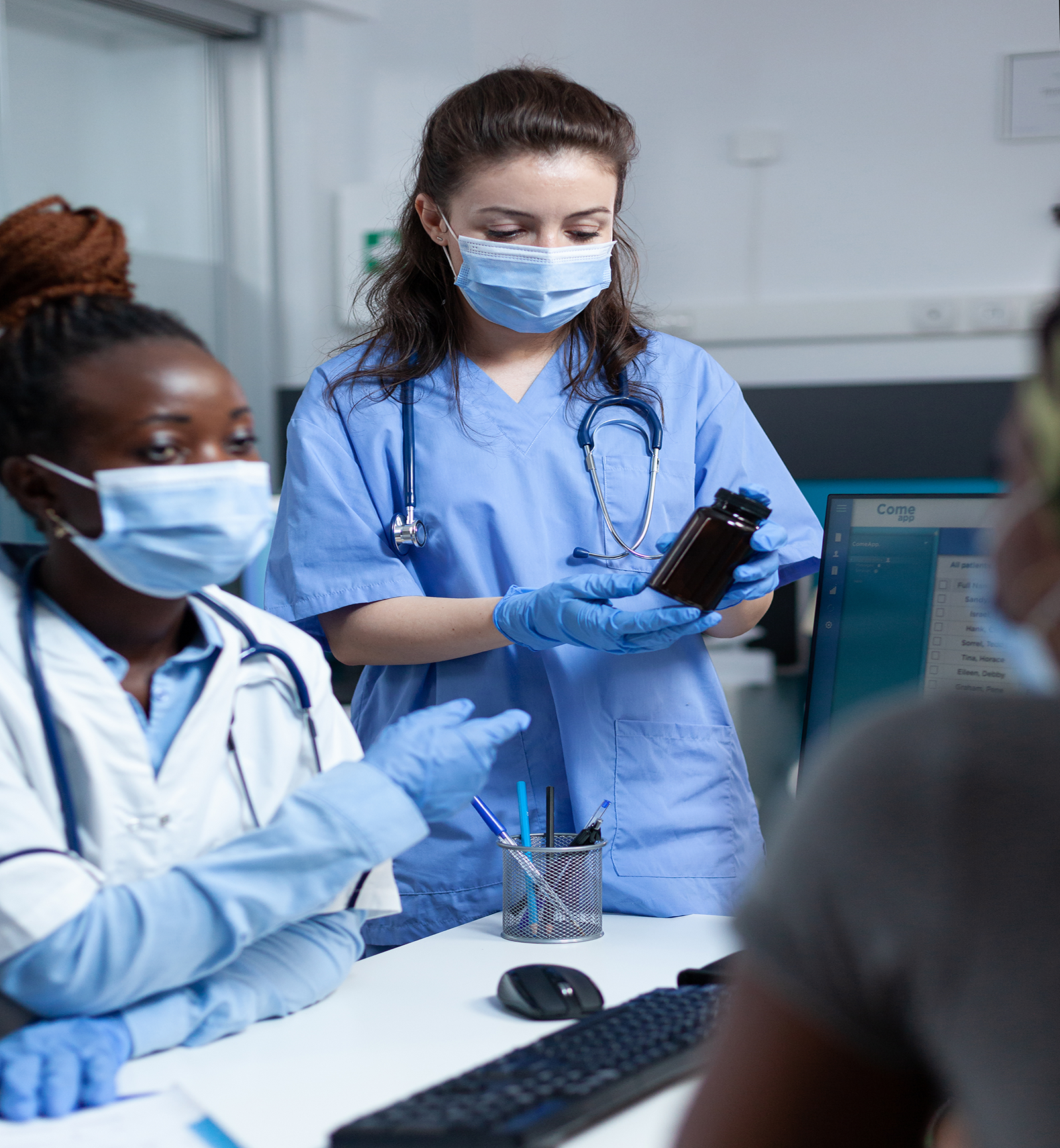 Nurses discussing medication with patient